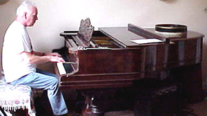 Gary sits at Linda's piano